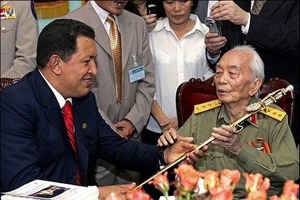 Gen. Vo Nguyen Giap, right, receives a sword from Venezuelan President Hugo Chavez, left,